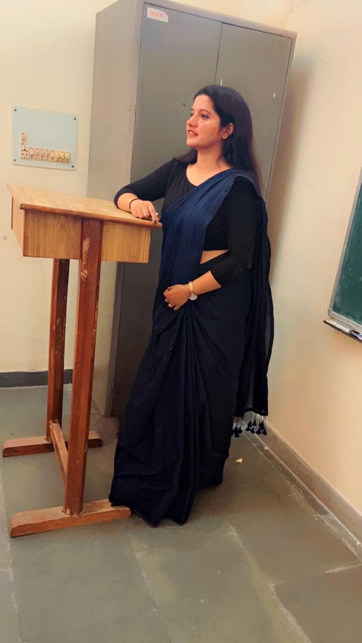 Tanuja Singh at the lectern during a lesson