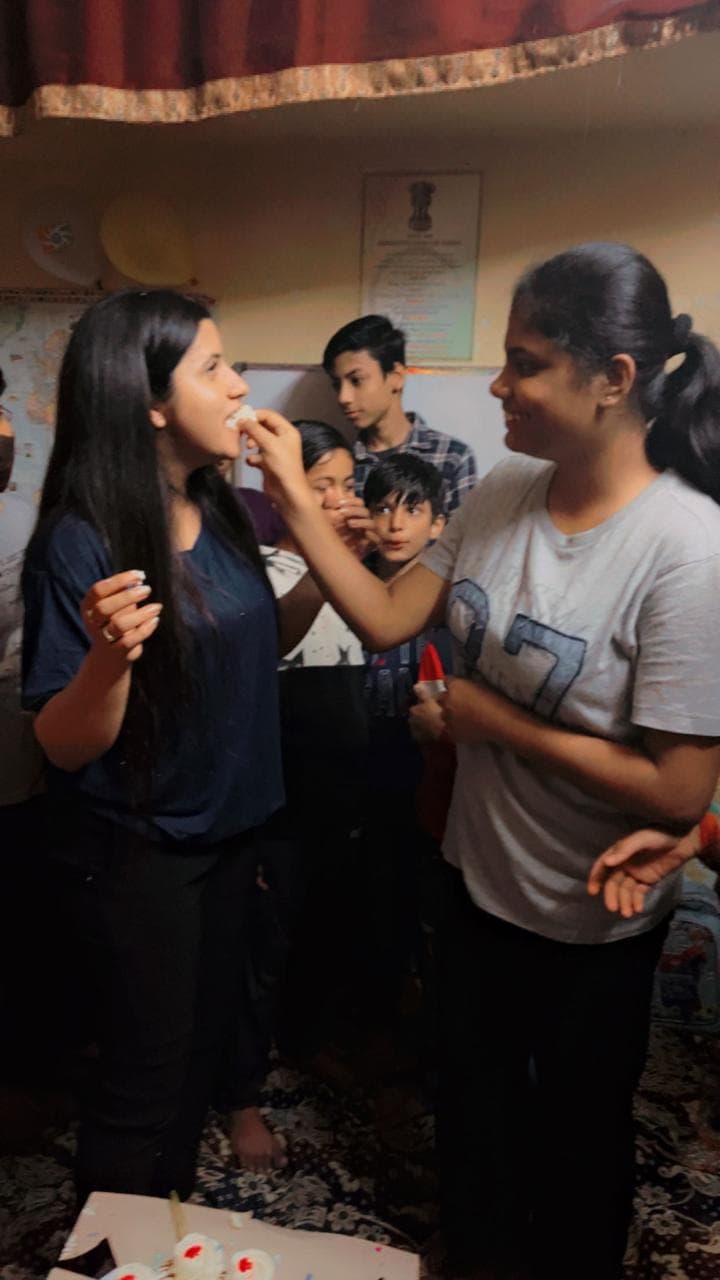 Tanuja Singh sharing cake with a student